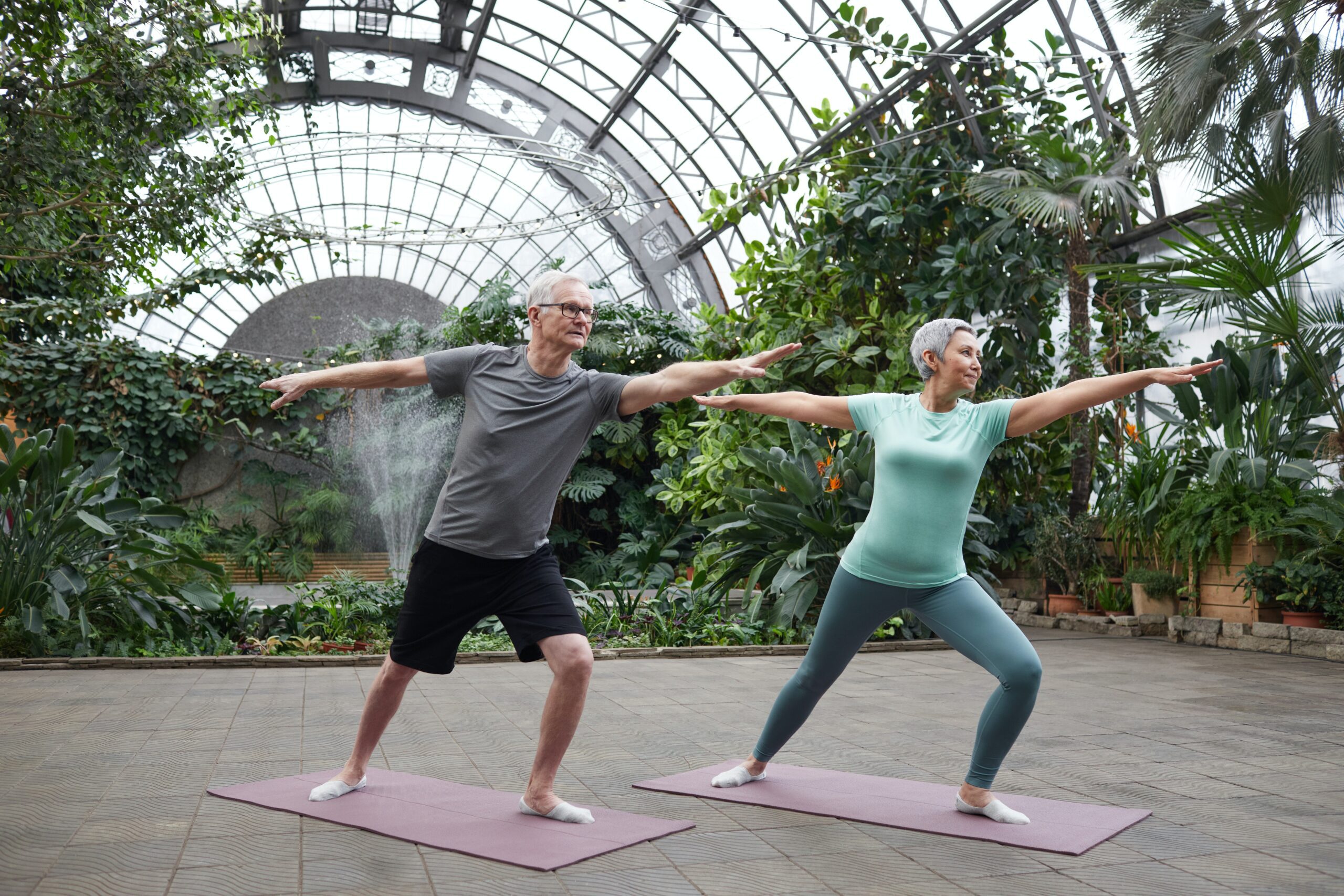Middle Aged American Male and Female in a Garden Yoga stretching